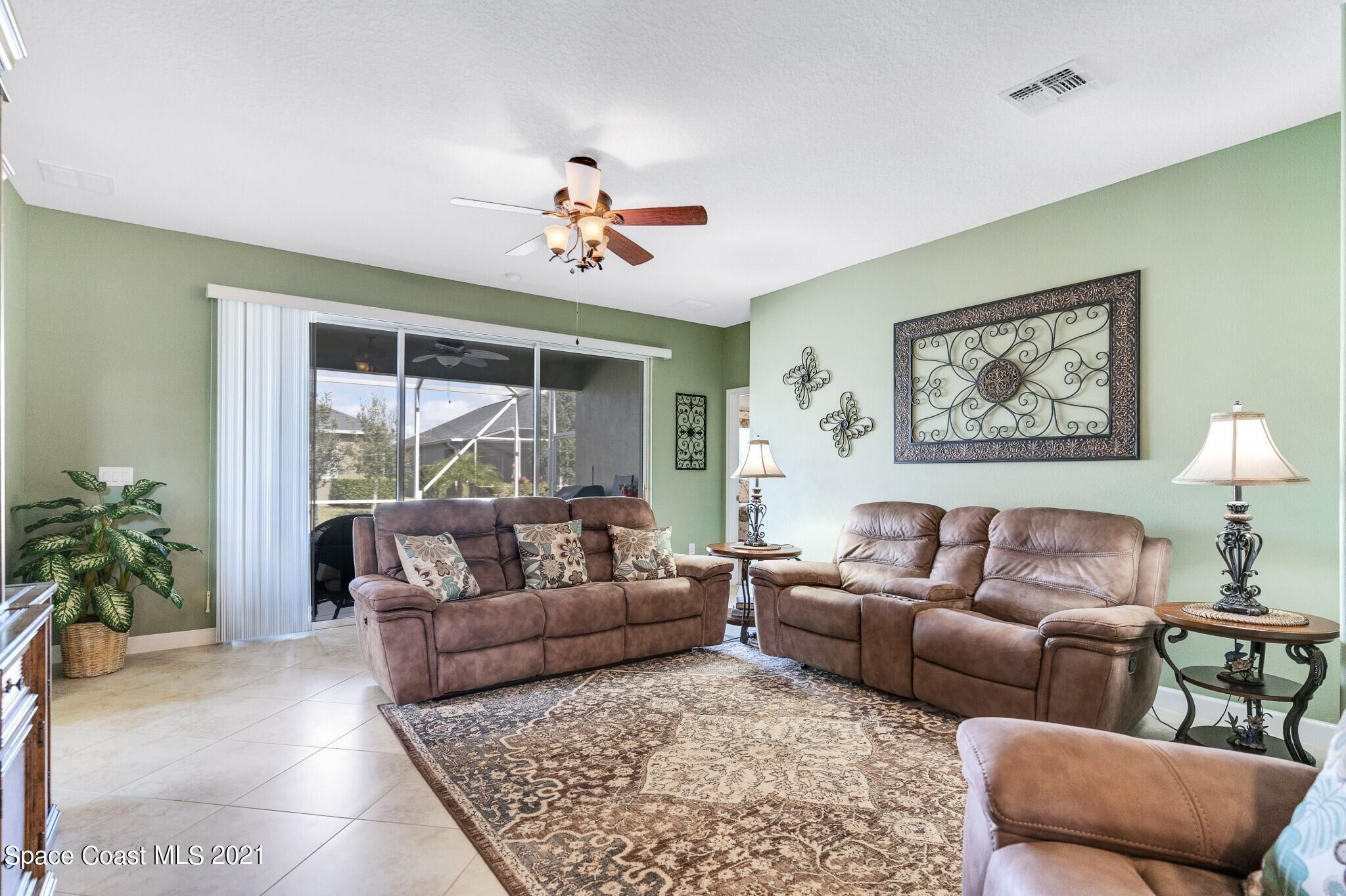 3242 Balboa Place Melbourne, FL 32940 - Photo 7 of 34 a living room with furniture and a large window