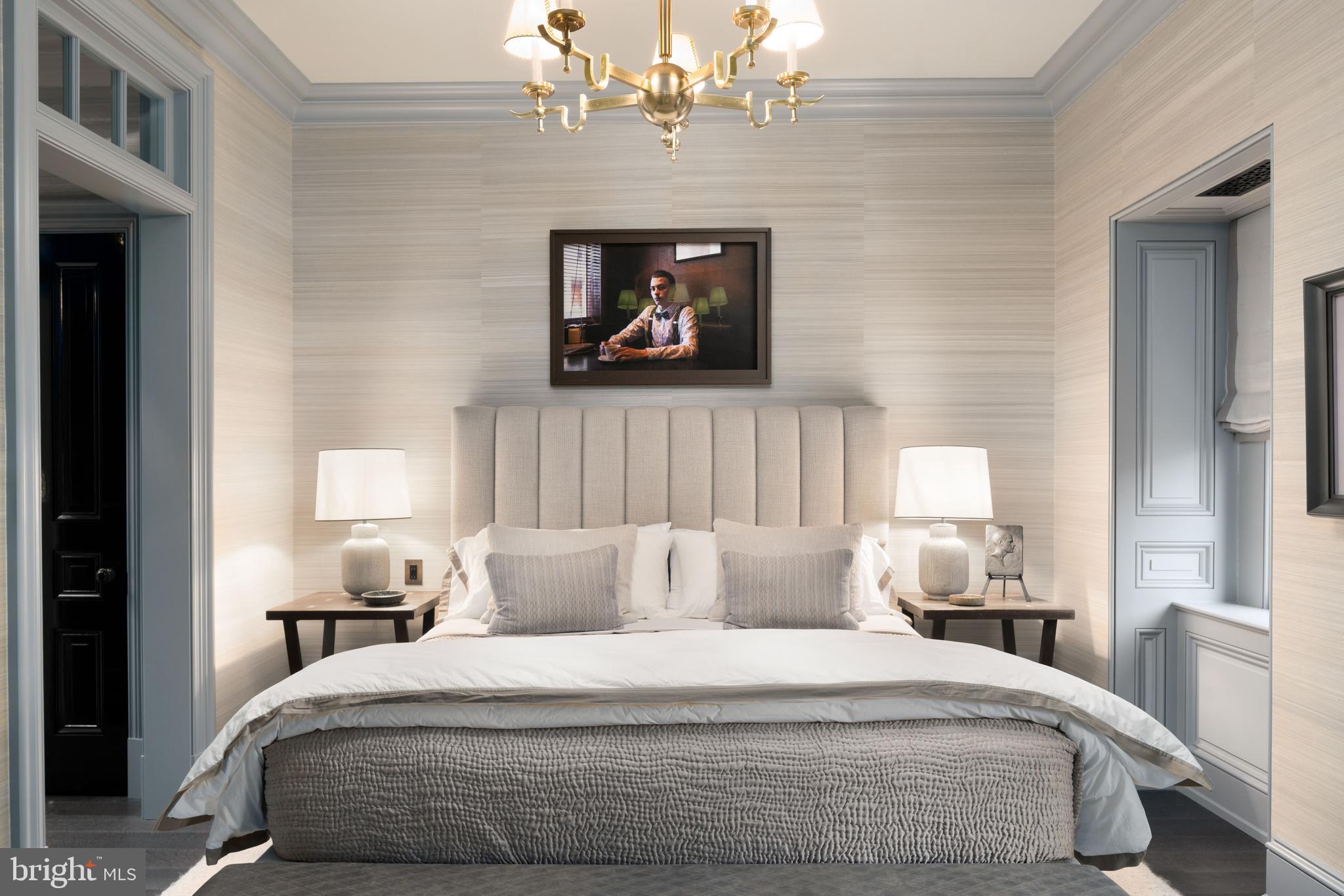 2041 Delancey Street Philadelphia, PA 19103 - Photo 25 of 29 a bedroom with a bed and a chandelier