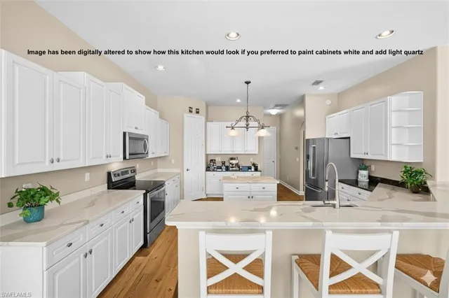 a kitchen with stainless steel appliances granite countertop a stove refrigerator and microwave