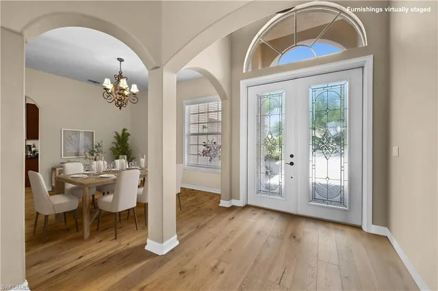 a view of hall way with furniture and wooden floor
