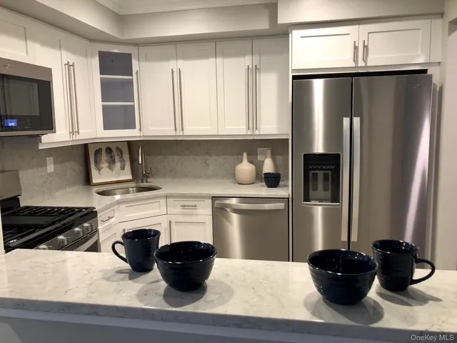 a kitchen with a refrigerator and a stove