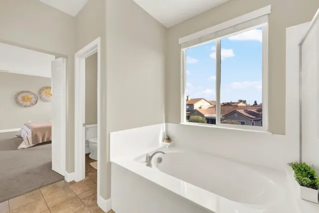 a white bath tub sitting next to a window