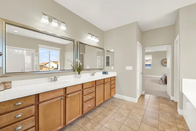 a spacious bathroom with a granite countertop sink mirror and a