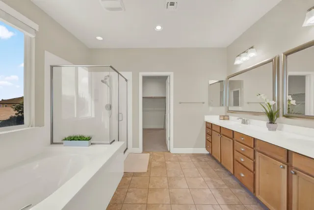 a bathroom with a double vanity sink and a bathtub