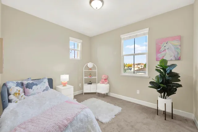 a bedroom with a bed and a potted plant