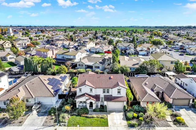 an aerial view of residential houses with outdoor space