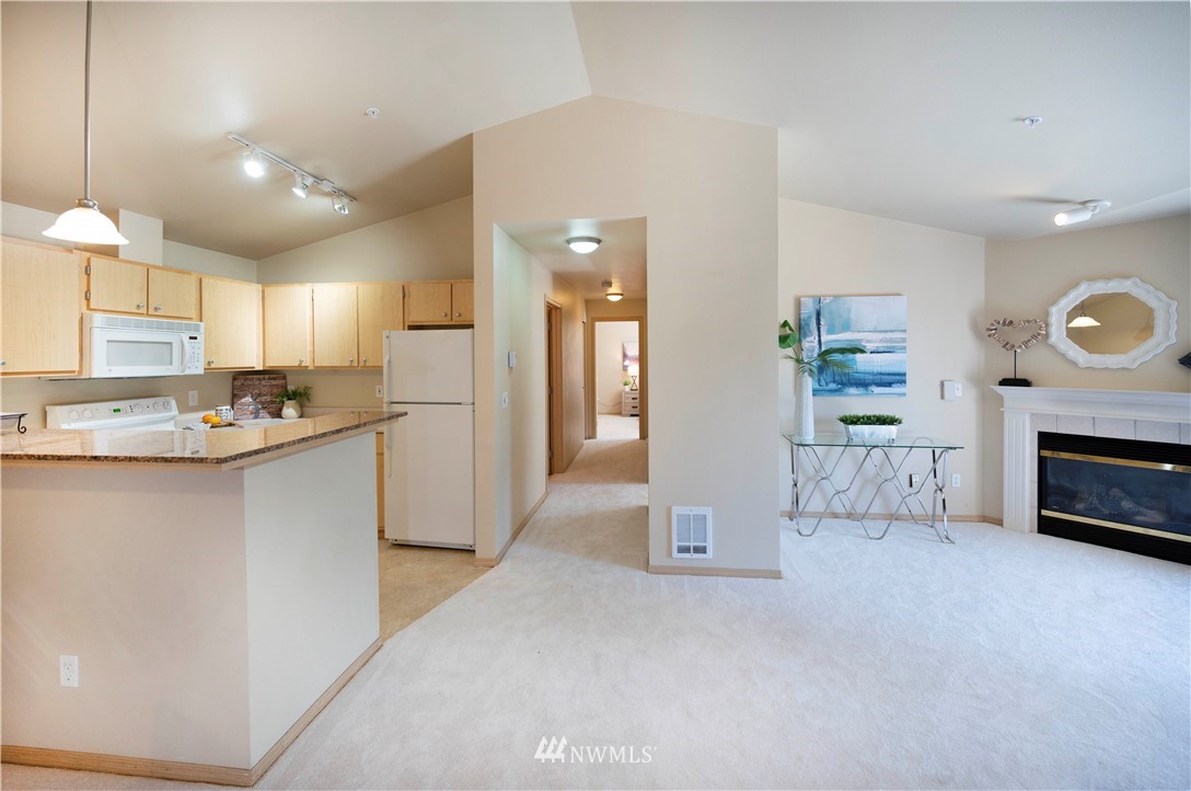 10709 Valley View Road, Unit A301 Bothell, WA 98011 - Photo 13 of 26 a kitchen with refrigerator and cabinets