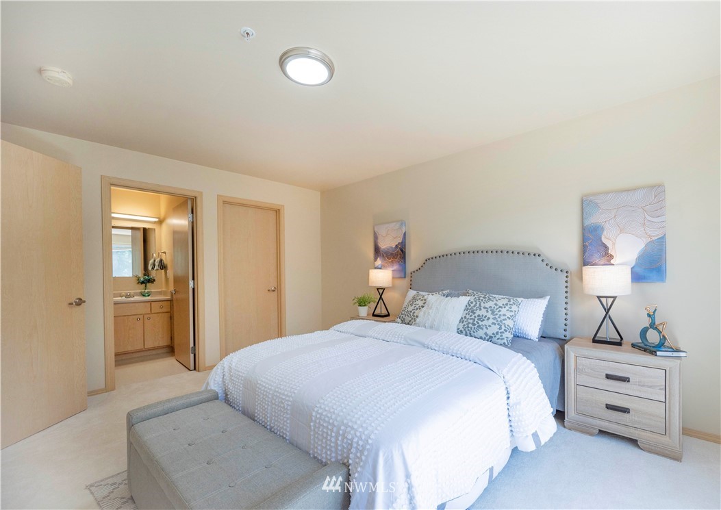 10709 Valley View Road, Unit A301 Bothell, WA 98011 - Photo 14 of 26 a bedroom with a bed and a lamp