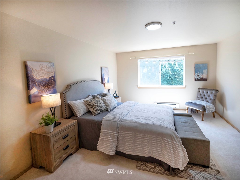 10709 Valley View Road, Unit A301 Bothell, WA 98011 - Photo 15 of 26 a bedroom with a bed and a chair