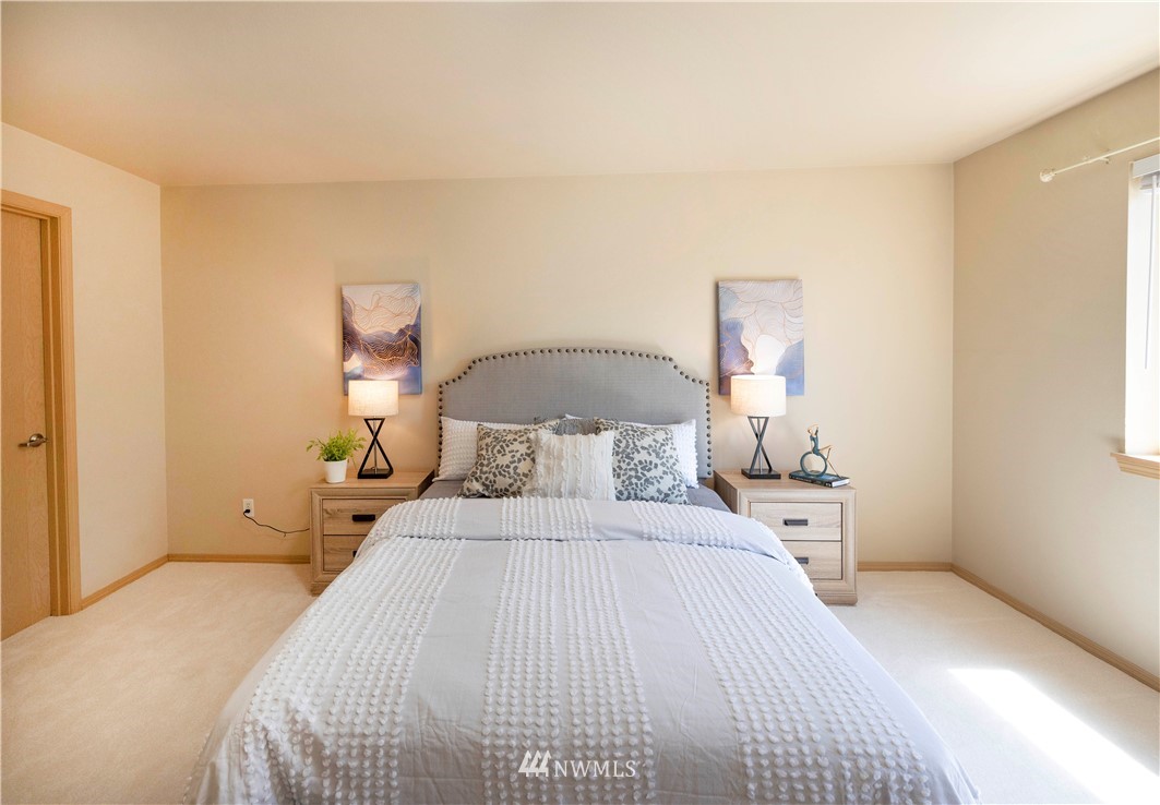 10709 Valley View Road, Unit A301 Bothell, WA 98011 - Photo 16 of 26 a bedroom with a bed and a night stand