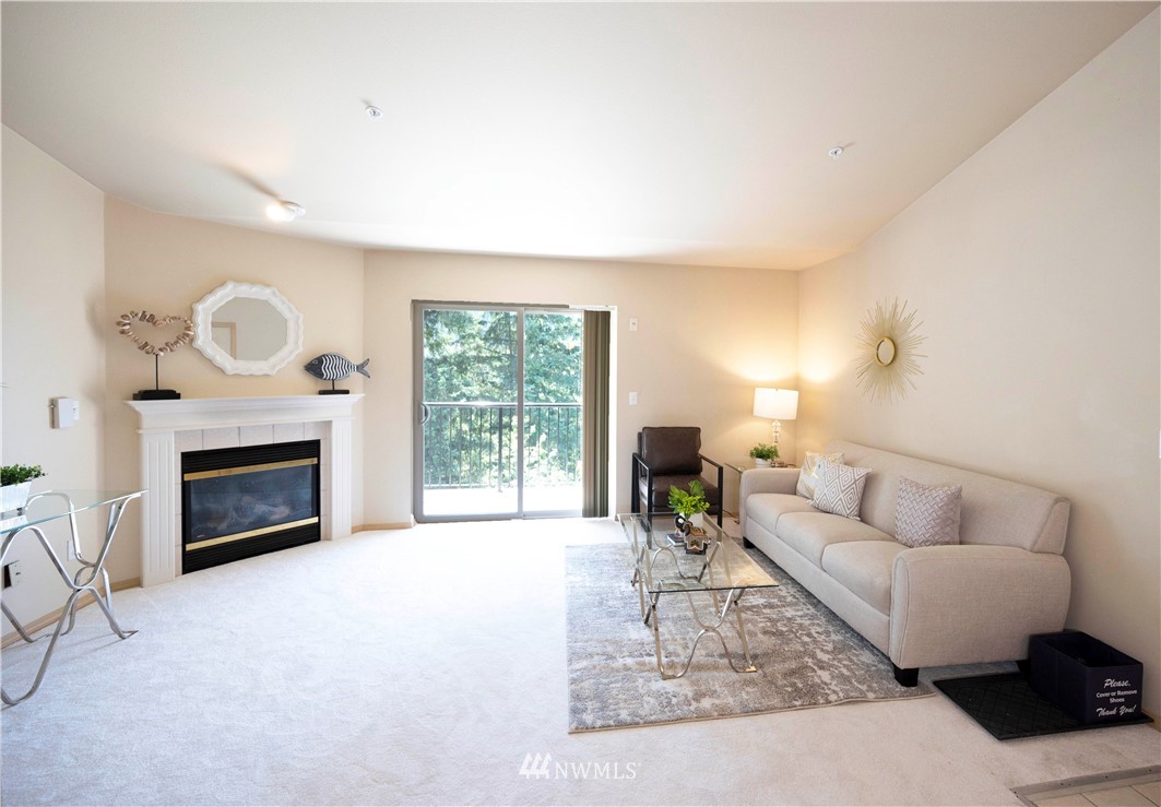 10709 Valley View Road, Unit A301 Bothell, WA 98011 - Photo 3 of 26 a living room with furniture and a fireplace