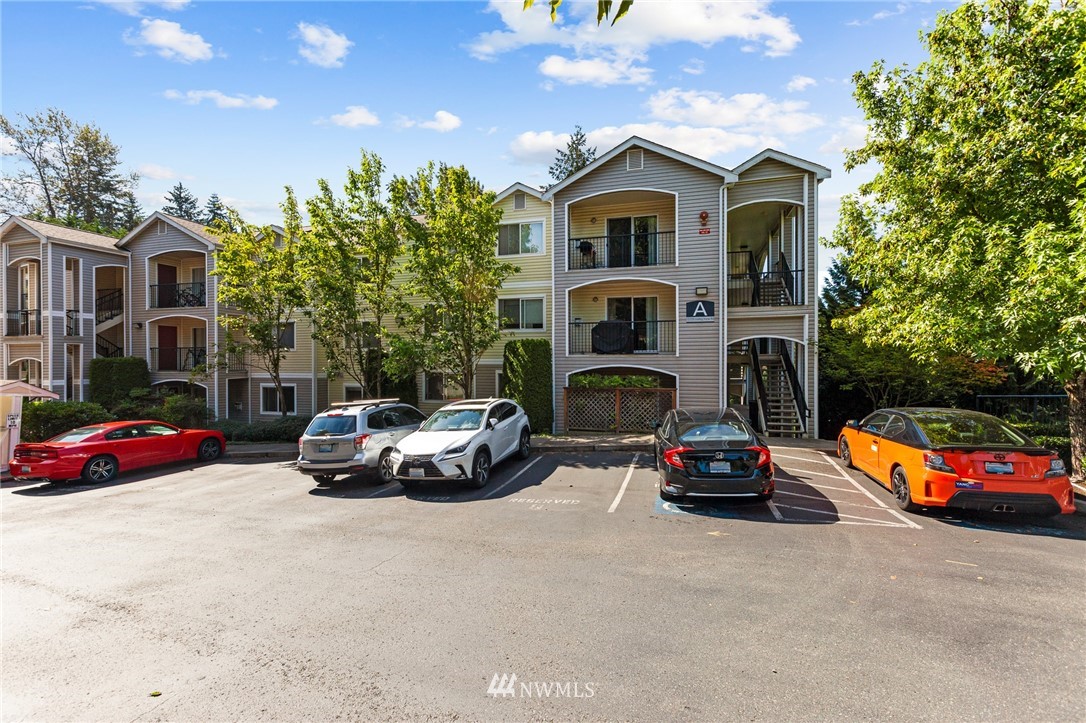 10709 Valley View Road, Unit A301 Bothell, WA 98011 - Photo 23 of 26 a car parked in front of white house