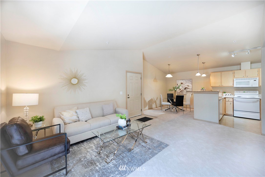 10709 Valley View Road, Unit A301 Bothell, WA 98011 - Photo 5 of 26 a living room with furniture and kitchen view