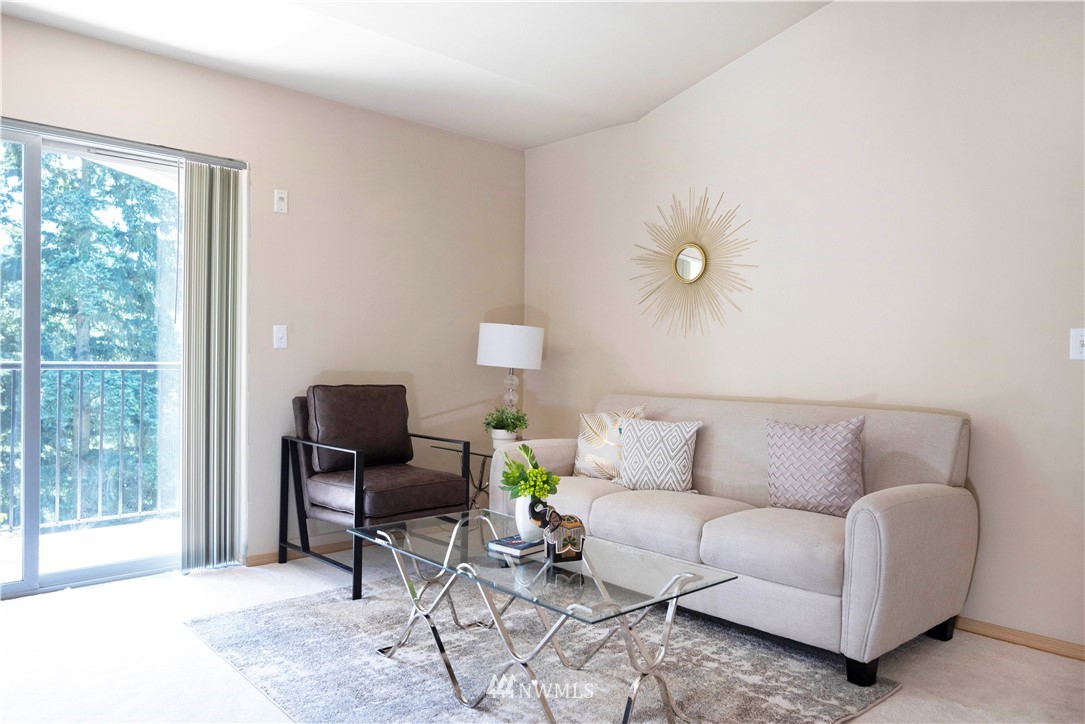 10709 Valley View Road, Unit A301 Bothell, WA 98011 - Photo 6 of 26 a living room with furniture and a large window