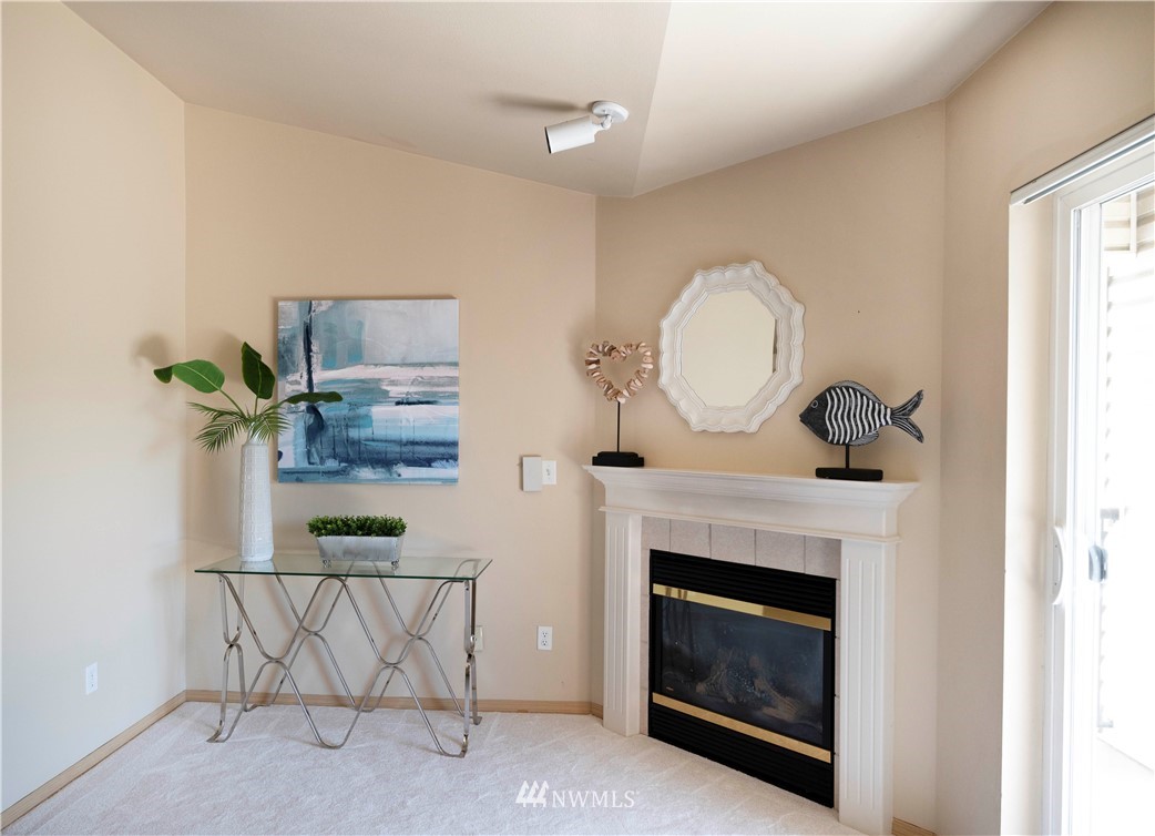10709 Valley View Road, Unit A301 Bothell, WA 98011 - Photo 7 of 26 a living room with furniture and a fireplace