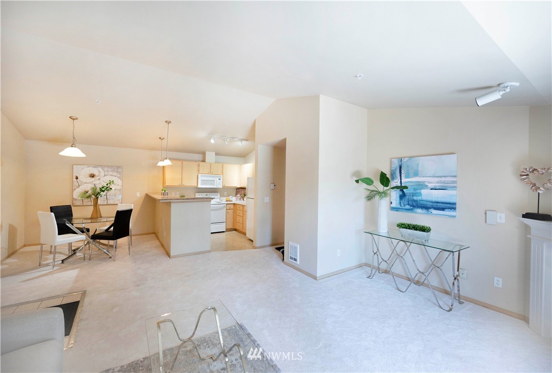 10709 Valley View Road, Unit A301 Bothell, WA 98011 - Photo 8 of 26 a living room with furniture and a kitchen area