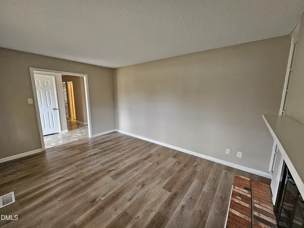 a view of empty room with fireplace