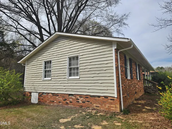 a front view of house with yard and trees