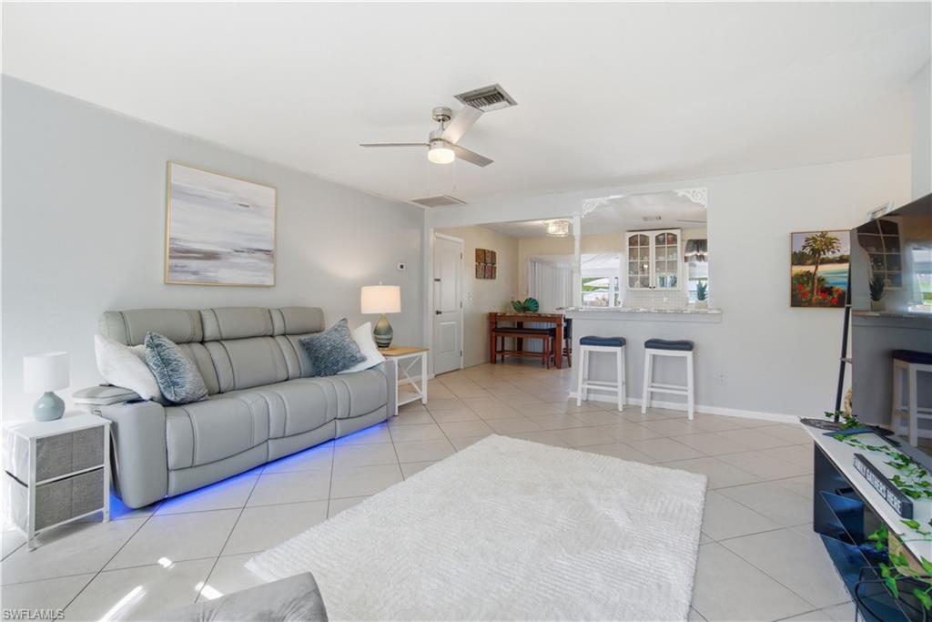 55 2nd Street Bonita Springs, FL 34134 - Photo 11 of 25 a living room with furniture and a flat screen tv