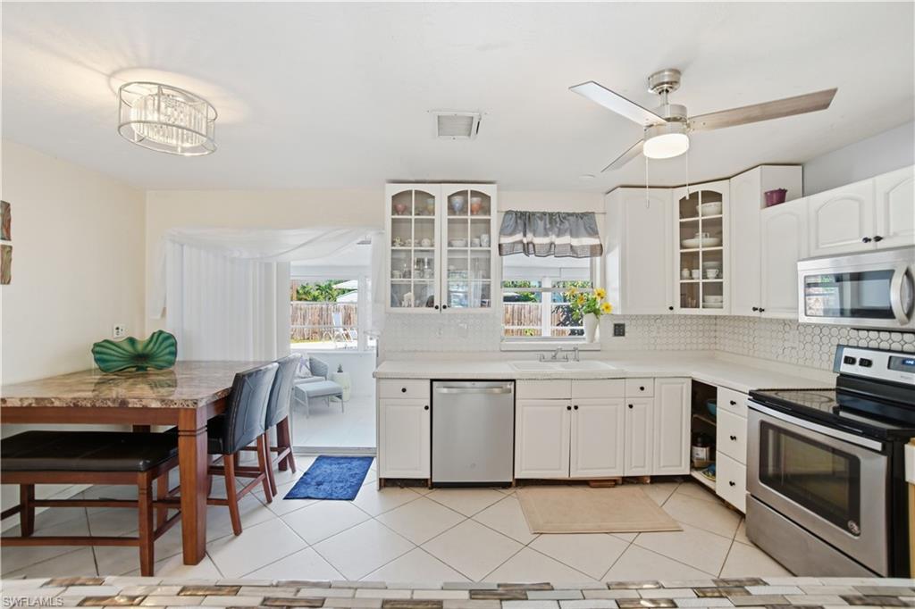 55 2nd Street Bonita Springs, FL 34134 - Photo 12 of 25 a open kitchen with stainless steel appliances granite countertop a stove and a sink