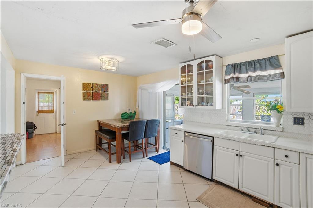 55 2nd Street Bonita Springs, FL 34134 - Photo 13 of 25 a view of a kitchen area with furniture and chandelier