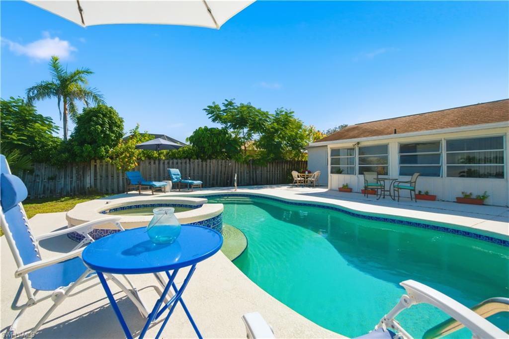 55 2nd Street Bonita Springs, FL 34134 - Photo 14 of 25 a view of a swimming pool with a patio and a yard