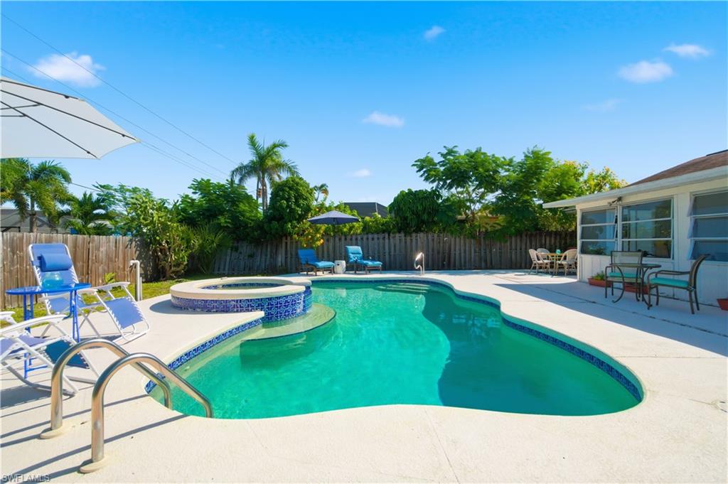 55 2nd Street Bonita Springs, FL 34134 - Photo 15 of 25 a swimming pool with outdoor seating and yard