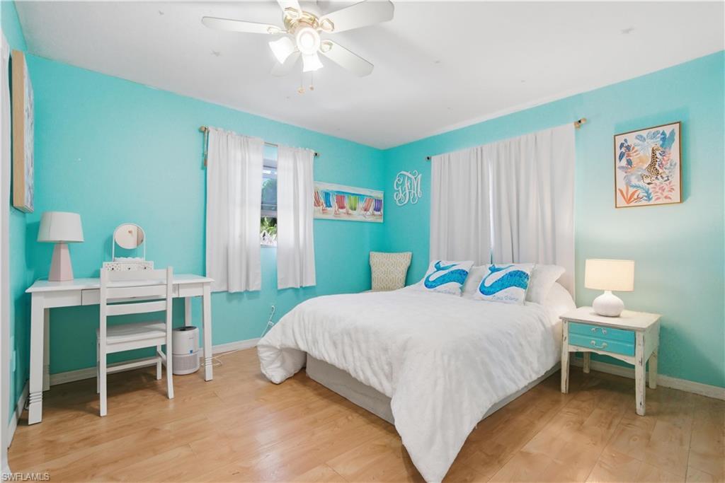 55 2nd Street Bonita Springs, FL 34134 - Photo 16 of 25 a bedroom with a bed and a table