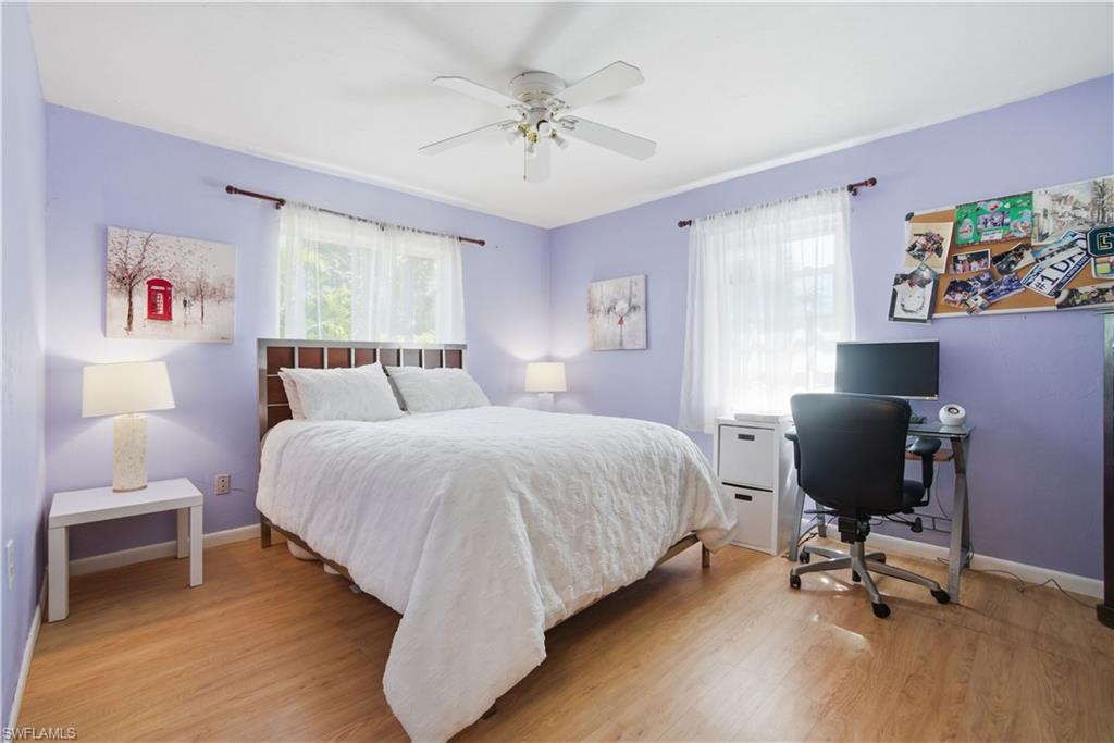 55 2nd Street Bonita Springs, FL 34134 - Photo 18 of 25 a bedroom with a bed and a chandelier