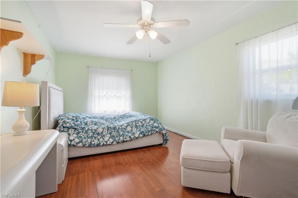 55 2nd Street Bonita Springs, FL 34134 - Photo 20 of 25 a bedroom with a bed and a couch