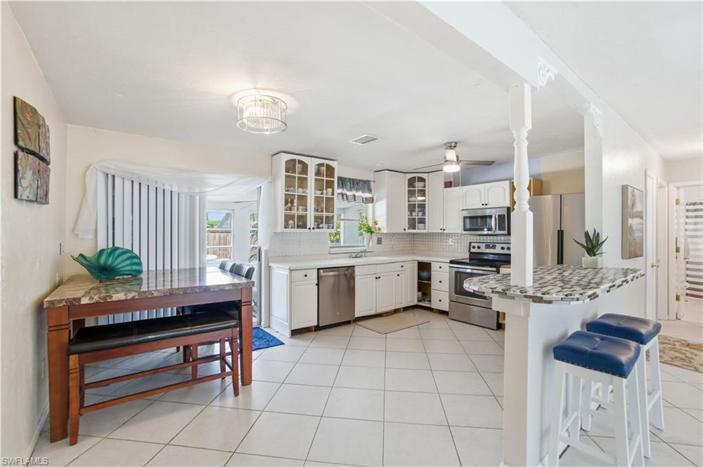 55 2nd Street Bonita Springs, FL 34134 - Photo 6 of 25 a kitchen with a stove a sink and a refrigerator