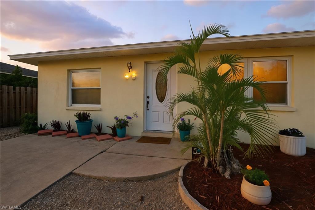 55 2nd Street Bonita Springs, FL 34134 - Photo 7 of 25 a building with potted plants in front of it