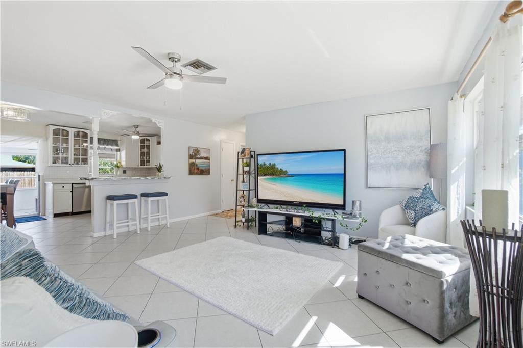 55 2nd Street Bonita Springs, FL 34134 - Photo 9 of 25 a living room with furniture and a flat screen tv