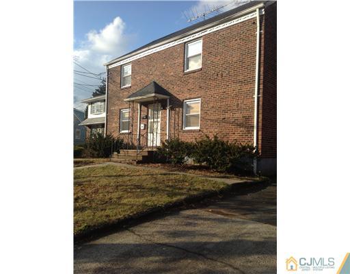 824 2nd Street, Unit 1 Dunellen, NJ 08812 - Photo 1 of 11 a view of a brick house next to a yard