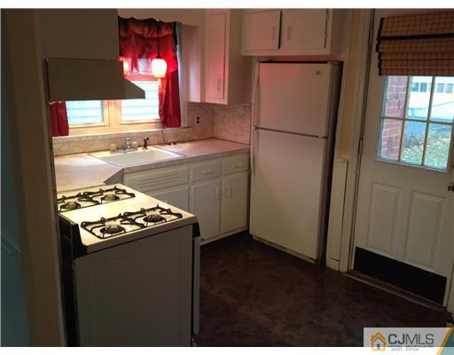 824 2nd Street, Unit 1 Dunellen, NJ 08812 - Photo 11 of 11 a kitchen with a refrigerator and a stove