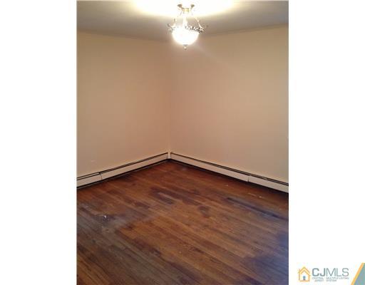 824 2nd Street, Unit 1 Dunellen, NJ 08812 - Photo 10 of 11 a view of an empty room with wooden floor