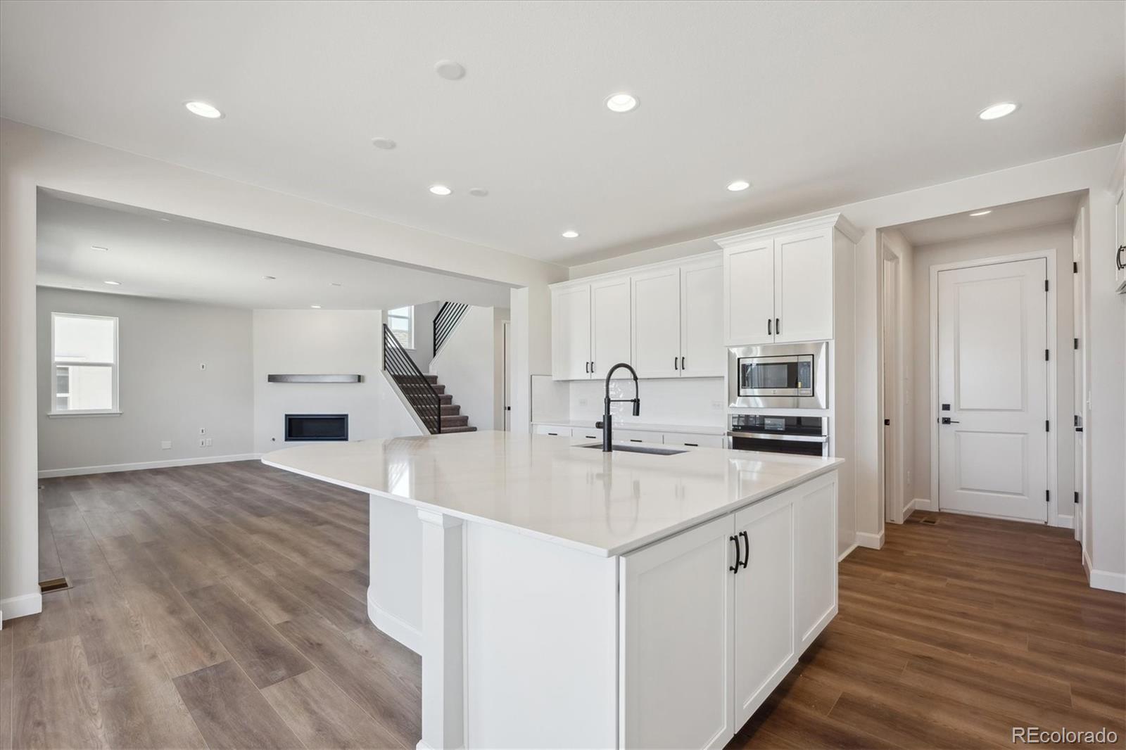 5583 Riverbend Avenue Firestone, CO 80504 - Photo 11 of 25 a kitchen with stainless steel appliances granite countertop a sink stove and cabinets