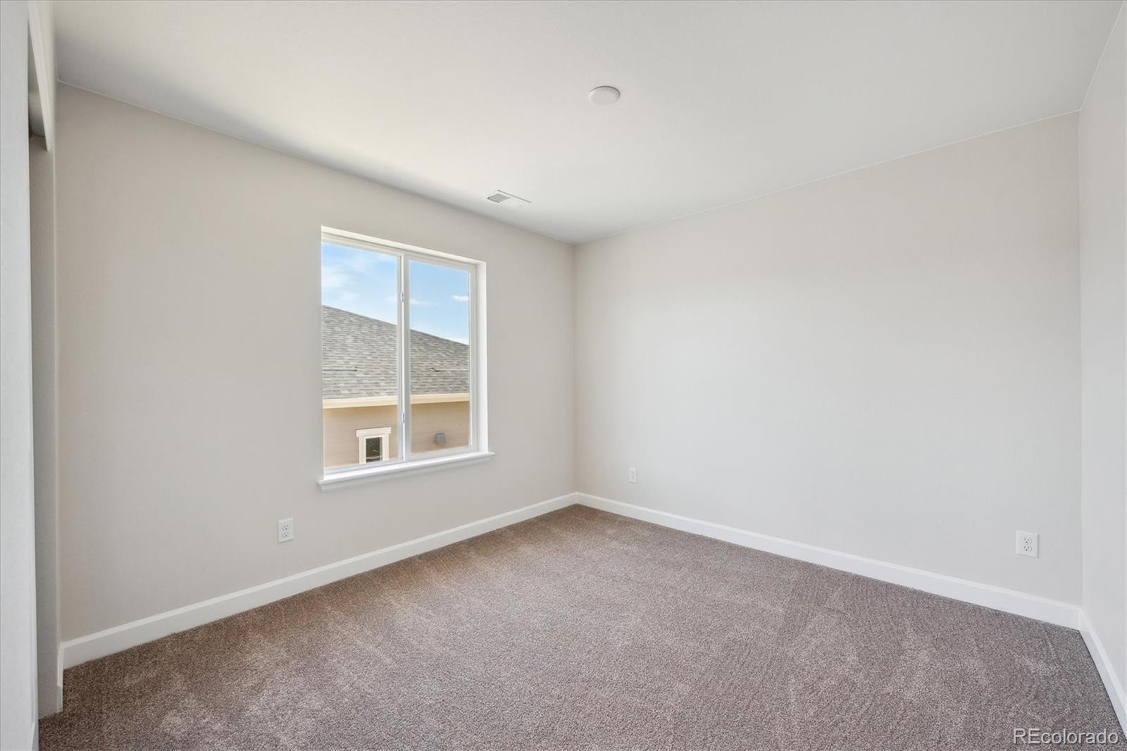 5583 Riverbend Avenue Firestone, CO 80504 - Photo 15 of 25 an empty room with a window