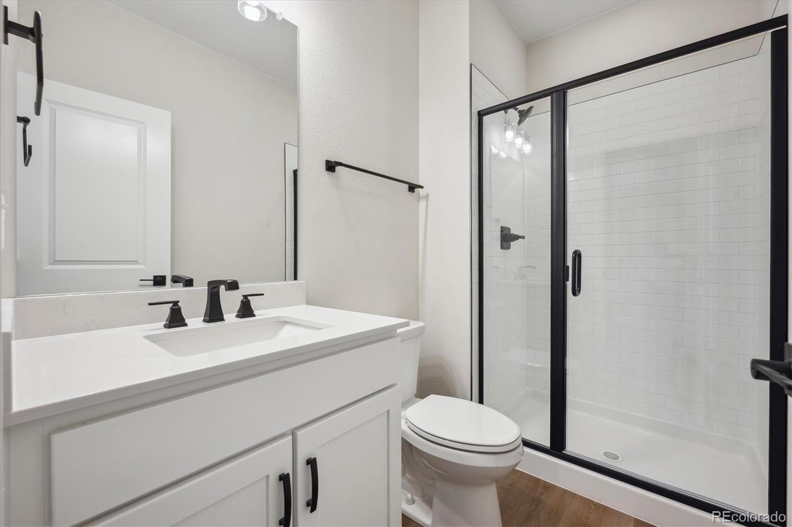 5583 Riverbend Avenue Firestone, CO 80504 - Photo 20 of 25 a bathroom with a sink a toilet and shower