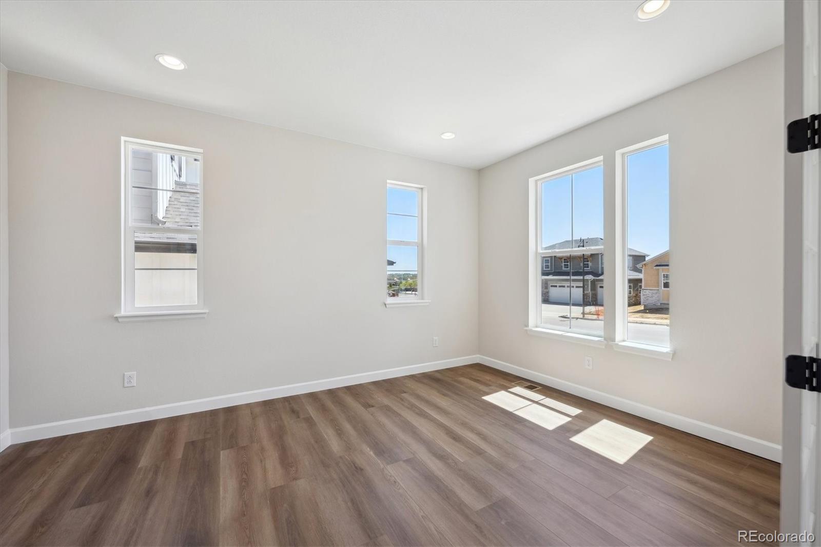 5583 Riverbend Avenue Firestone, CO 80504 - Photo 2 of 25 a view of empty room with wooden floor and fan