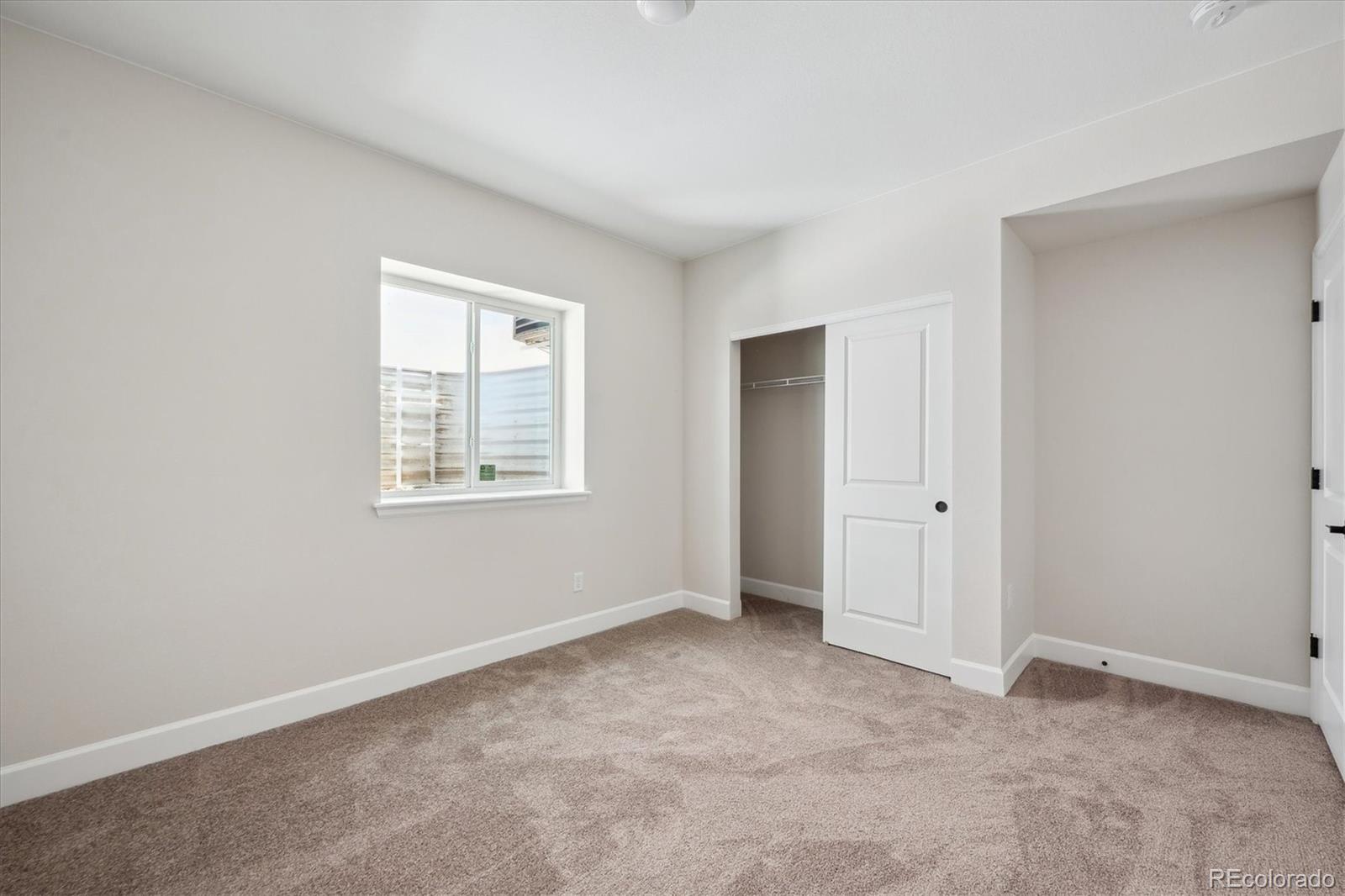 5583 Riverbend Avenue Firestone, CO 80504 - Photo 21 of 25 a view of an empty room with a window