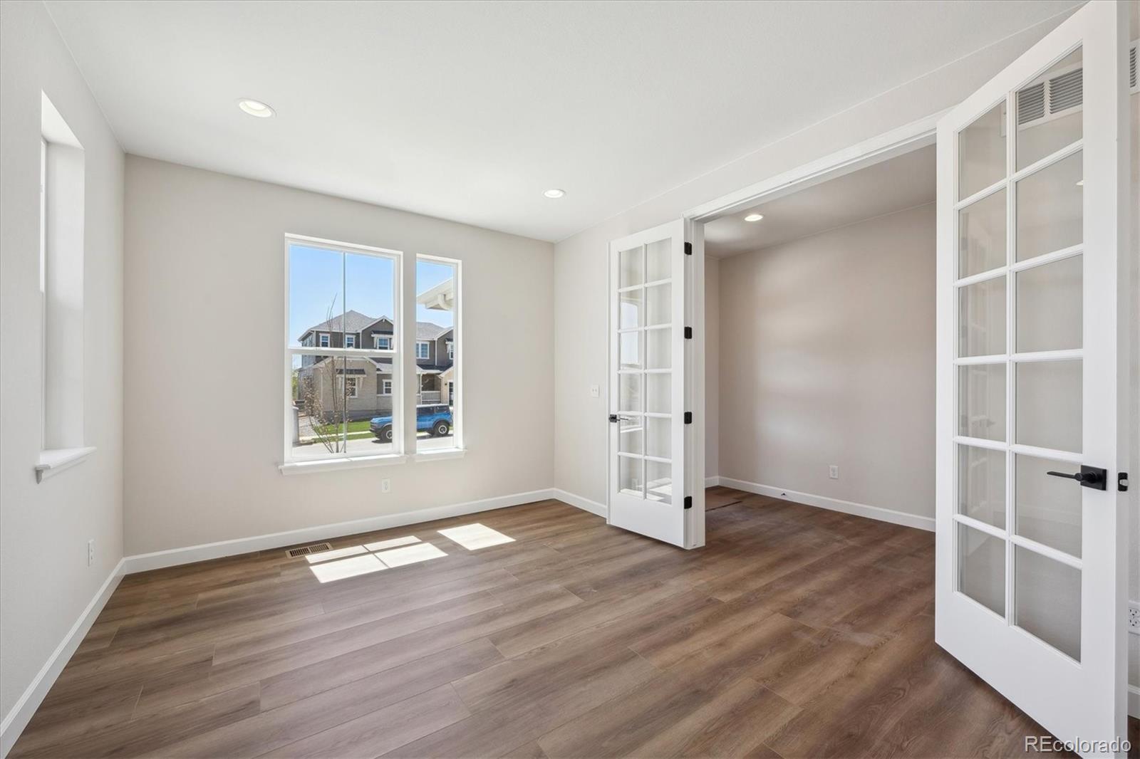5583 Riverbend Avenue Firestone, CO 80504 - Photo 3 of 25 an empty room with wooden floor and window
