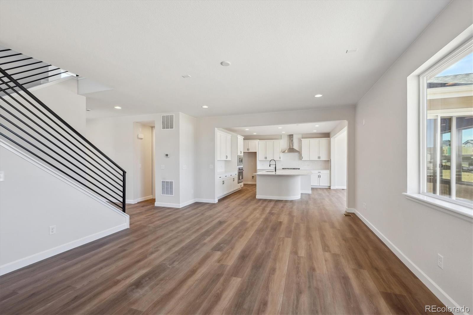 5583 Riverbend Avenue Firestone, CO 80504 - Photo 6 of 25 a view of a living room with wooden floor