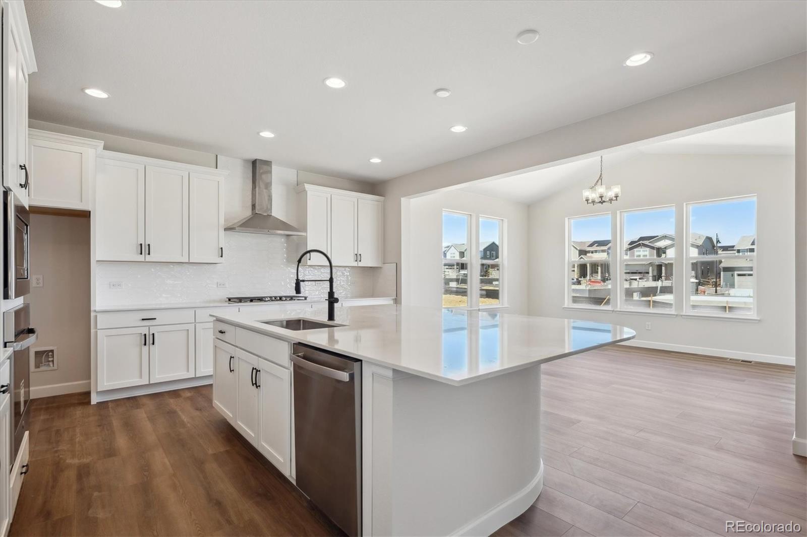 5583 Riverbend Avenue Firestone, CO 80504 - Photo 8 of 25 a large kitchen with stainless steel appliances granite countertop a large center island and a sink