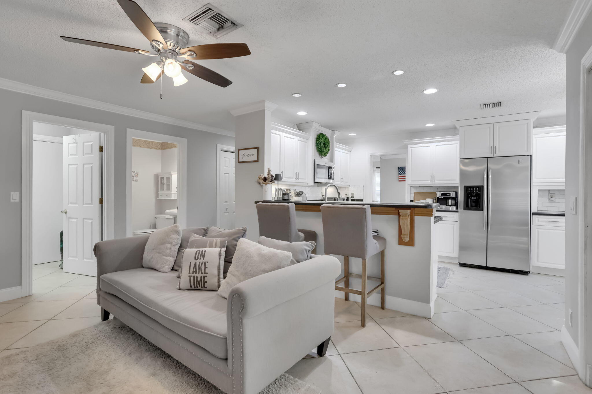 7424 Ashley Shores Circle Lake Worth, FL 33467 - Photo 13 of 33 a living room with stainless steel appliances kitchen island granite countertop furniture and a view of kitchen
