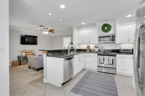 a kitchen with a refrigerator and a stove top oven