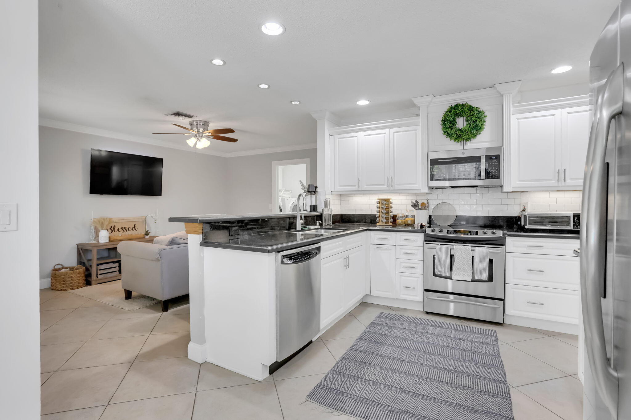 7424 Ashley Shores Circle Lake Worth, FL 33467 - Photo 15 of 33 a kitchen with a refrigerator and a stove top oven