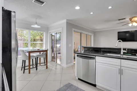 a kitchen with stainless steel appliances granite countertop a stove and a sink