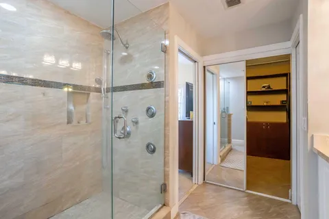 a bathroom with a shower and a glass door
