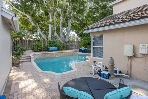 a view of a backyard with furniture and outdoor seating
